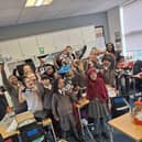 Chestnut Park students holding their new trainers aloft