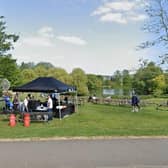 Students enjoying University of Surrey land including lake. (Credit: Google Street View)