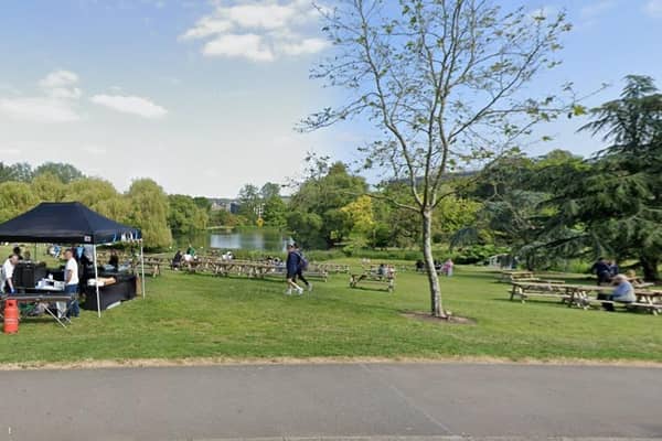 Students enjoying University of Surrey land including lake. (Credit: Google Street View)