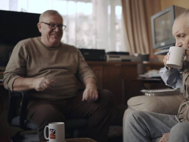Volunteer Liam (left) with blind veteran Ken enjoying a cup of tea and a chat. Picture submitted