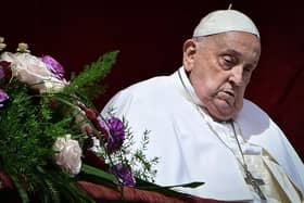 Pope Francis stands at the main balcony of St. Peter's basilica for the Urbi et Orbi message and blessing to the city and the world as part of Easter celebrations, at St Peter's square in the Vatican on April 20, 2025. (Photo by Tiziana FABI / AFP) (Photo by TIZIANA FABI/AFP via Getty Images)