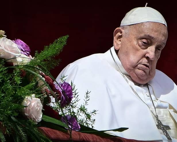 Pope Francis stands at the main balcony of St. Peter's basilica for the Urbi et Orbi message and blessing to the city and the world as part of Easter celebrations, at St Peter's square in the Vatican on April 20, 2025. (Photo by Tiziana FABI / AFP) (Photo by TIZIANA FABI/AFP via Getty Images)