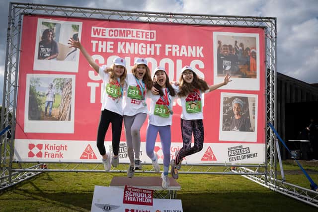 A team celebrating their completion of the 2024 Charterhouse Schools Triathlon