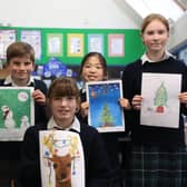 Children with the winning entries in the festive card design competition at Highfield and Brookham. Picture: submitted