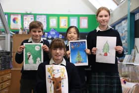 Children with the winning entries in the festive card design competition at Highfield and Brookham. Picture: submitted
