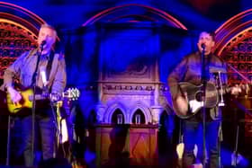 Bragg on tour playing guitar up for auction for Blake's Cottage