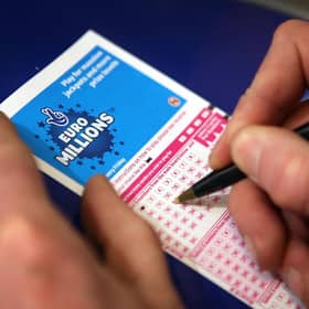 Filling out a lottery ticket.