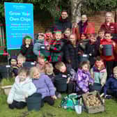 Pupils from Badshot Lea Village Infant School get planting their own potatoes with the help of Squire’s Badshot Lea Plant Team members, Jack (back left) and Jo (back right).