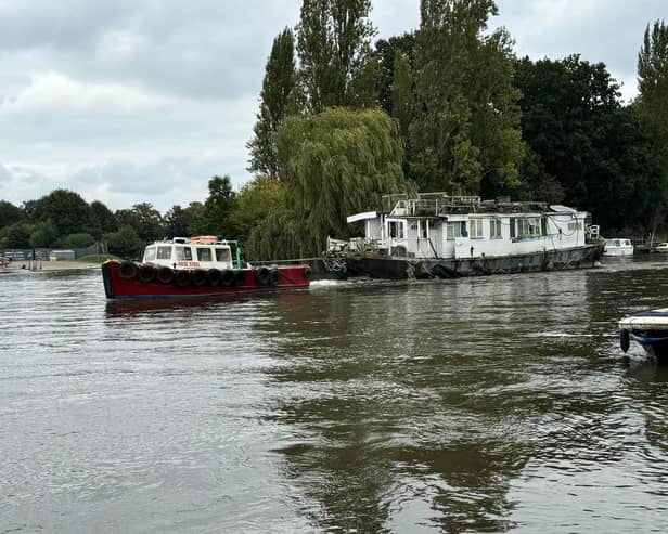 Boat being towed away by joint enforcement in Molesey, Elmbridge. (Credit: Cllr Kevin Whincup)