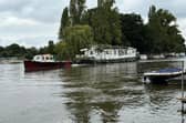 Boat being towed away by joint enforcement in Molesey, Elmbridge. (Credit: Cllr Kevin Whincup)