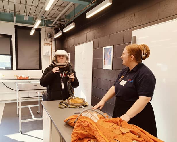 An Alton College student tries on a space helmet.