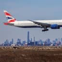 A Boeing 777 passenger aircraft of British Airways arrives from London at JFK International Airport in New York as the Manhattan skyline looms in the background on February 7, 2024. (Photo by Charly TRIBALLEAU / AFP) (Photo by CHARLY TRIBALLEAU/AFP via Getty Images)