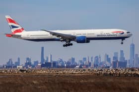 A Boeing 777 passenger aircraft of British Airways arrives from London at JFK International Airport in New York as the Manhattan skyline looms in the background on February 7, 2024. (Photo by Charly TRIBALLEAU / AFP) (Photo by CHARLY TRIBALLEAU/AFP via Getty Images)