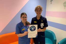 The Children and Young People's Service Team proudly holding their 'You're Welcome' accreditation certificate