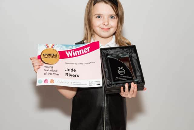 Jude Rivers proudly shows off her award