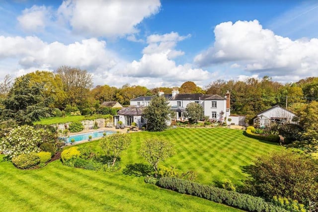 The swimming pool is in the garden in front of the annexe