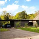 Lake Cottage at Smallfield is set in nearly five acres of grounds and is on sale through agents Savills with a guide price of £1,500,000