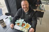 Mark Dunford tries out the new hot honey glaze at Wingstop in Crawley