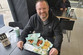 Mark Dunford tries out the new hot honey glaze at Wingstop in Crawley