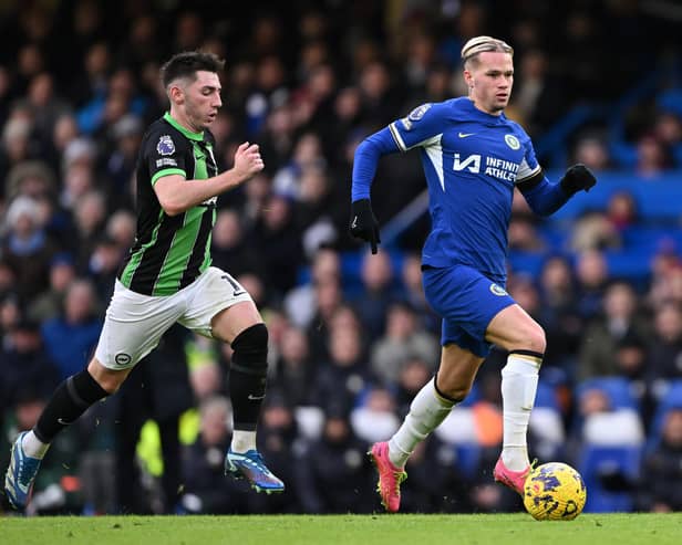 Mykhaylo Mudryk of Chelsea runs with the ball whilst under pressure from Billy Gilmour of Brighton & Hove Albion during the Premier League match between Chelsea FC and Brighton & Hove Albion at Stamford Bridge on December 03, 2023 in London, England. (Photo by Mike Hewitt/Getty Images)