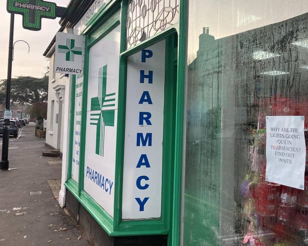 Outside South Street Pharmacy, Dorking, with protest poster in the window. (Credit: Emily Dalton/LDRS)