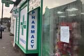 Outside South Street Pharmacy, Dorking, with protest poster in the window. (Credit: Emily Dalton/LDRS)