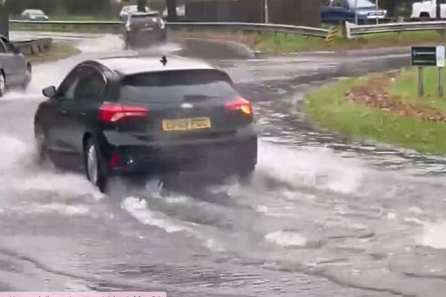 Vehicles navigating floodwater in Crawley this morning (November 27)