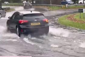 Vehicles navigating floodwater in Crawley this morning (November 27)