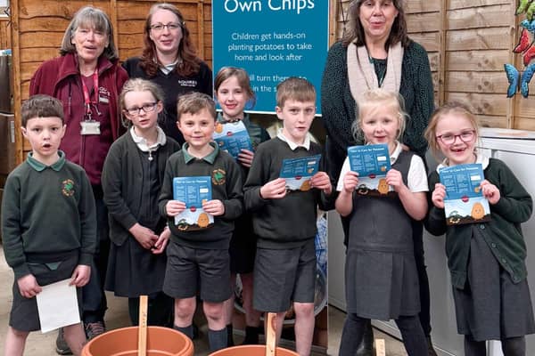 Pupils from The Horsell Village School, with some of Squire’s Woking’s Plant Experts (back left), during  their visit to Squire’s Woking, taking part in Squire’s Grow Your Own Chips initiative.