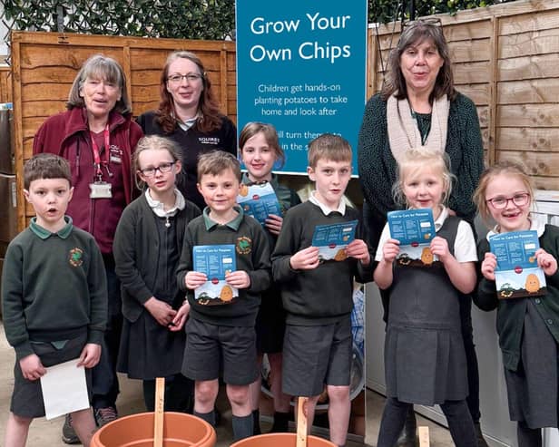 Pupils from The Horsell Village School, with some of Squire’s Woking’s Plant Experts (back left), during  their visit to Squire’s Woking, taking part in Squire’s Grow Your Own Chips initiative.