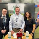 Davinia Hadley, practice manager at Specsavers Dorking, with optical advisor Fletcher O'Riordan and BBC Surrey sports editor Tim Durrans at the latest Specsavers Surrey Senior Cup draw in January 2025