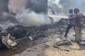 Firefighters work at the site where Air India flight 171 crashed in a residential area near the airport in Ahmedabad on June 12, 2025. The London-bound passenger plane crashed on June 12 in India's western city of Ahmedabad with 242 on board, aviation officials said in what the airline called a "tragic accident". (Photo by Sam PANTHAKY / AFP) (Photo by SAM PANTHAKY/AFP via Getty Images)