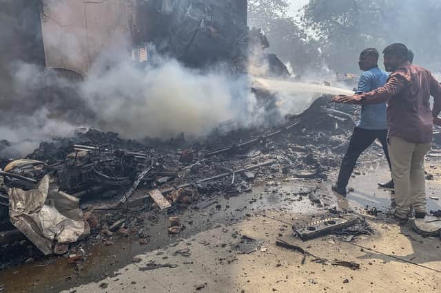 Firefighters work at the site where Air India flight 171 crashed in a residential area near the airport in Ahmedabad on June 12, 2025. The London-bound passenger plane crashed on June 12 in India's western city of Ahmedabad with 242 on board, aviation officials said in what the airline called a "tragic accident". (Photo by Sam PANTHAKY / AFP) (Photo by SAM PANTHAKY/AFP via Getty Images)