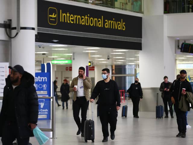 LONDON, ENGLAND - MARCH 27: Travellers walk through Gatwick Airport on March 27, 2022 in London, England. Gatwick's South terminal closed in June 2020 to reduce costs during the Coronvirus pandemic when traveller numbers reduced significantly. It has undergone months of refurbishment and re-opens today to meet the expected increased demand for air travel over Easter and the coming summer now that restrictions have been lifted. (Photo by Hollie Adams/Getty Images)