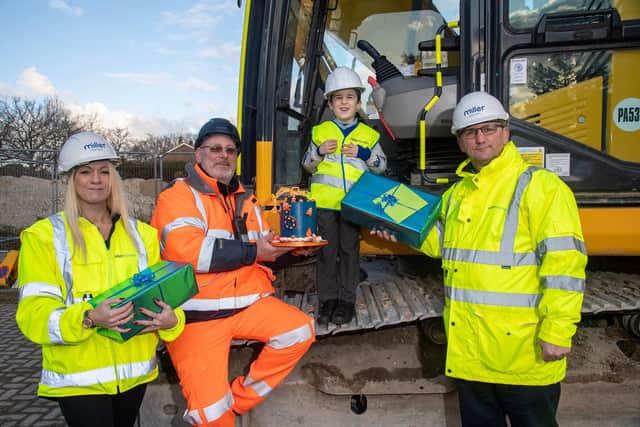 Louie Thomas on a digger, alongside Laura Worley, marketing manager from Miller Homes Southern, John Nuthall, site manager from Collard Contracting, and Paul Coombes, production director from Miller Homes Southern