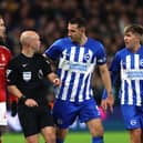 Lewis Dunk of Brighton & Hove Albion talks to Referee, Anthony Taylor during the Premier League match between Nottingham Forest and Brighton & Hove Albion at City Ground on November 25, 2023 in Nottingham, England. (Photo by Eddie Keogh/Getty Images)