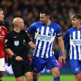 Lewis Dunk of Brighton & Hove Albion talks to Referee, Anthony Taylor during the Premier League match between Nottingham Forest and Brighton & Hove Albion at City Ground on November 25, 2023 in Nottingham, England. (Photo by Eddie Keogh/Getty Images)
