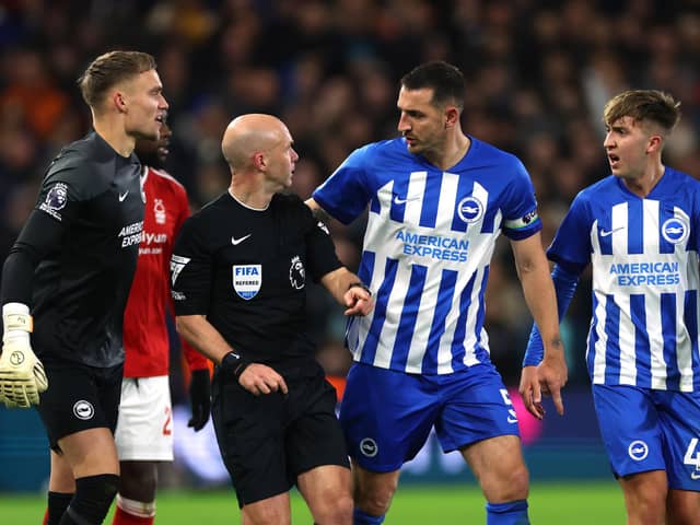 Lewis Dunk of Brighton & Hove Albion talks to Referee, Anthony Taylor during the Premier League match between Nottingham Forest and Brighton & Hove Albion at City Ground on November 25, 2023 in Nottingham, England. (Photo by Eddie Keogh/Getty Images)