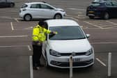 Warden Issuing A Parking Charge Notice. (Credit: Unsplash/Caspar Rae)