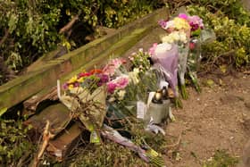 Floral tributes are being left at the West Sussex scene where a young woman died and her sister and cousin were seriously injured in a collision with a BMW