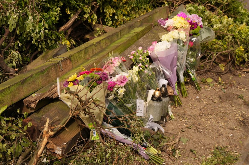 Floral tributes are being left at the West Sussex scene where a young woman died and her sister and cousin were seriously injured in a collision with a BMW