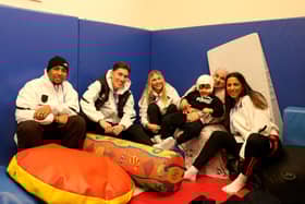 Siddique, age three, currently on placement at The Children's Trust for rehabilitation, with some stars of the Fulham men's and women's teams. Picture contributed