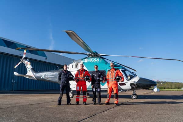 KSS crew with the helicopter the charity now owns rather than leases