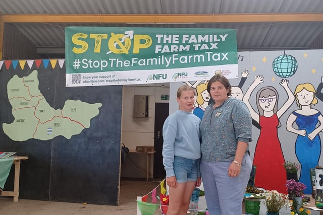 Surrey farmer and NFU Redhill branch chair Nellie Budd with her daughter Latasha, in front of an NFU Stop Family Farm Tax banner in the Young Farmers Club marquee at the South of England Show in West Sussex.