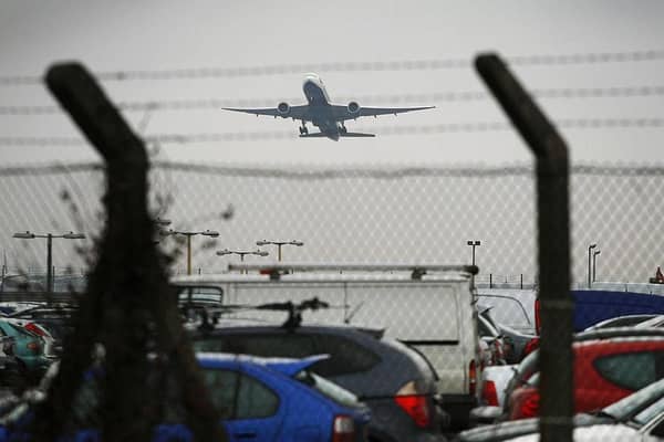 An aircraft takes off over a car park at Heathrow Airport. Picture by ADRIAN DENNIS/AFP via Getty Images